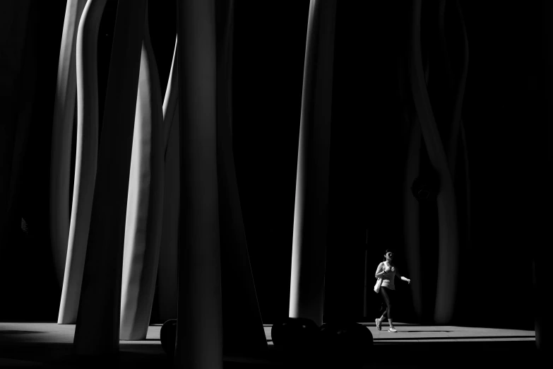 a black and white photo of a person on a skateboard, inspired by Ryoji Ikeda, conceptual art, playing harp in magical forest, standing in an arena, award arhitectural photography, in a candy forest! at night