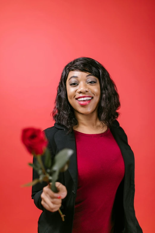 a woman holding a rose in front of a red background, keter class, professional profile picture, taliyah, high-quality photo