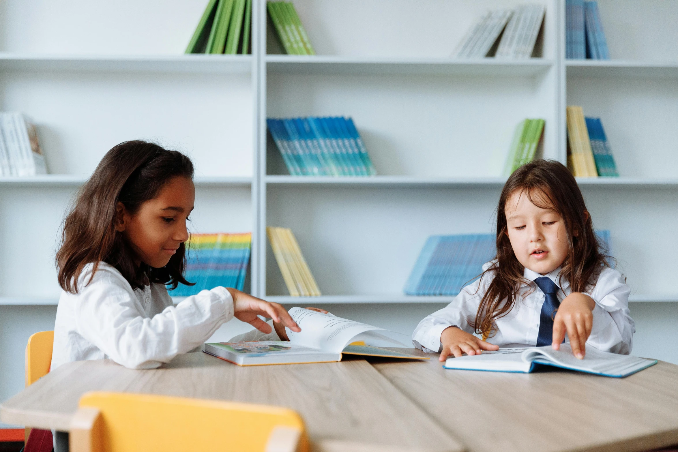 two little girls sitting at a table reading books, pexels contest winner, ashcan school, avatar image, classroom background, high resolution, commercially ready