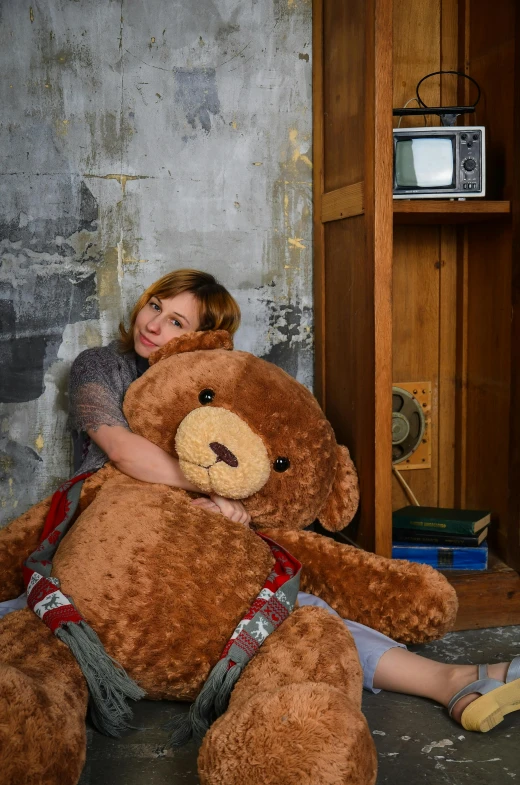 a woman is hugging a large teddy bear, inspired by Ilya Glazunov, shot with sony alpha, grungy, brown, toys