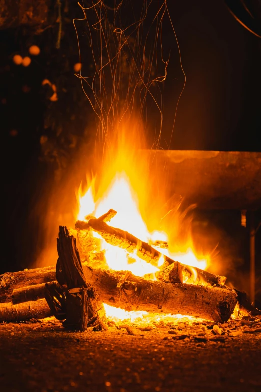 a person sitting in front of a campfire at night, pexels, smouldering charred timber, fire place roaring, winter setting, avatar image