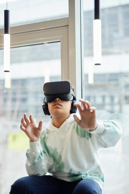 a woman sitting on a window sill wearing a virtual reality headset, shutterstock, interactive art, school class, boy, square, 2050