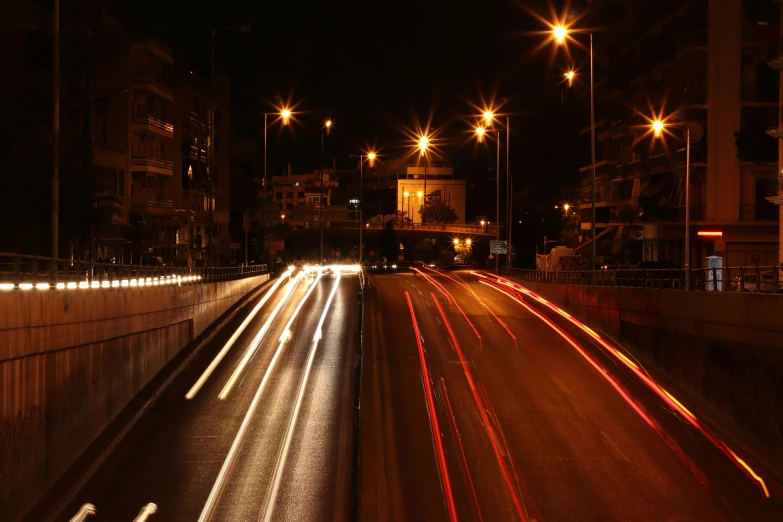 a city street filled with lots of traffic at night, by Ahmed Yacoubi, pexels contest winner, graffiti, high speed, damascus, ponte 2 5 de abril, opening scene