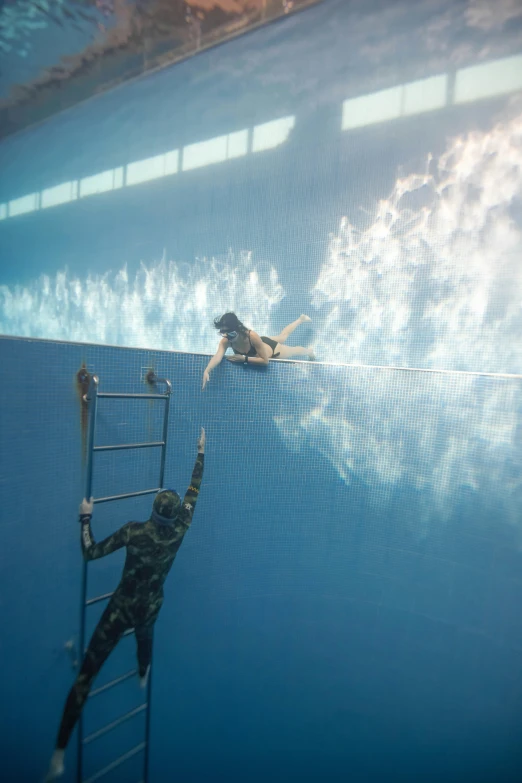 a couple of people that are swimming in a pool, a hyperrealistic painting, by Leandro Erlich, unsplash, underwater combat scene, taken in the late 2010s, zezhou chen, deep!!!!!