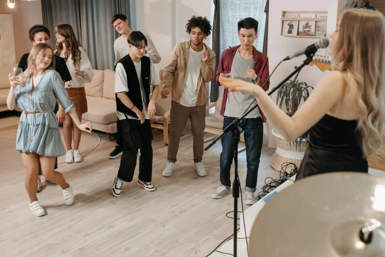 a group of people that are standing in a room, an album cover, trending on pexels, playing games, performing a music video, teenage, practice