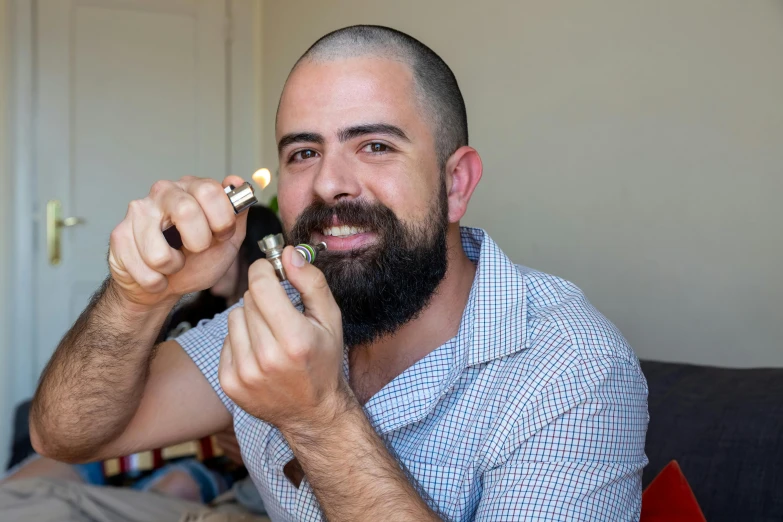 a man sitting on a couch brushing his teeth, inspired by Germán Londoño, featured on reddit, photorealism, holding a small vape, professional closeup photo, small nixie tubes, australian