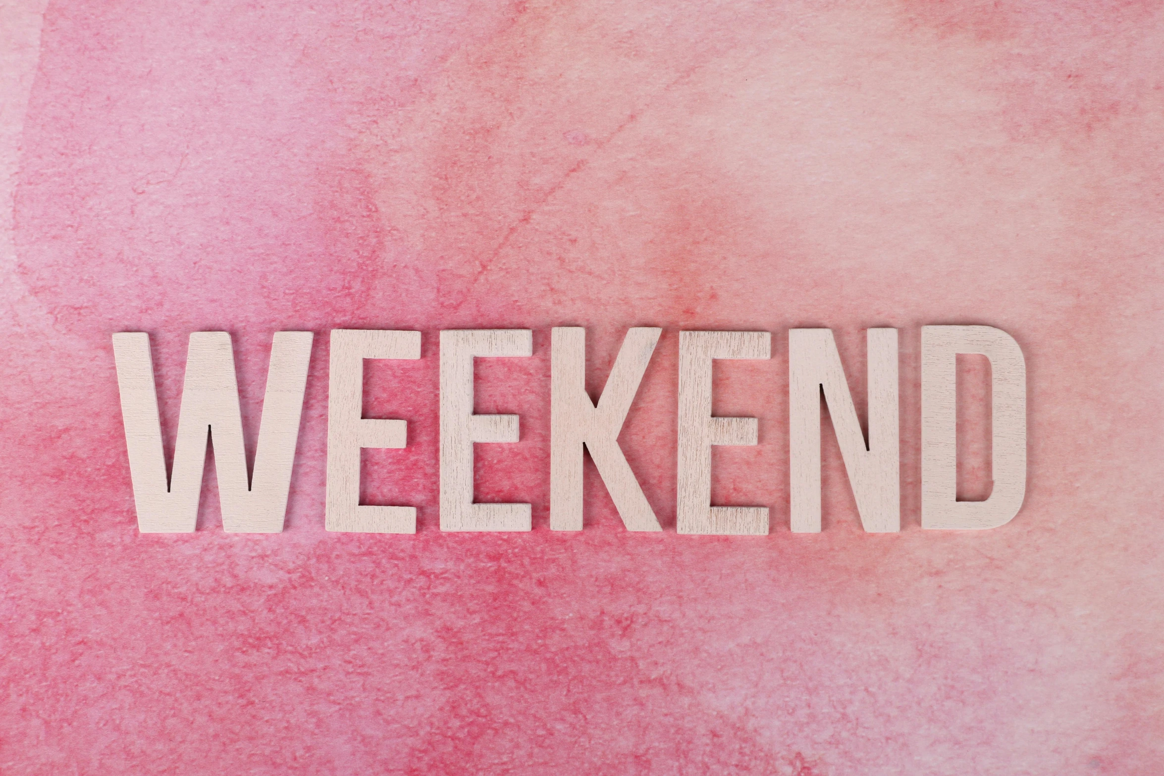 a pink watercolor background with the word weekend written on it, pixabay, wooden, posed, sam shearon, festivals