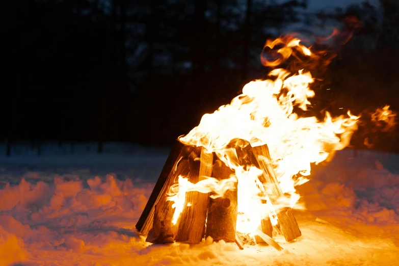 a bonfire is lit up in the snow, by Veikko Törmänen, shutterstock, lit from the side, close up shot, instagram photo, profile picture