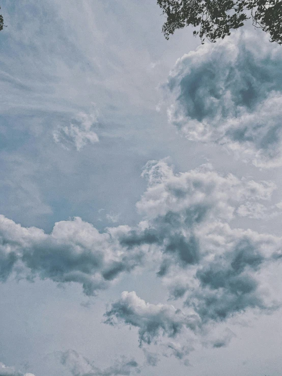 a man flying a kite on top of a lush green field, unsplash contest winner, aestheticism, layered stratocumulus clouds, ☁🌪🌙👩🏾, grey, cotton candy clouds