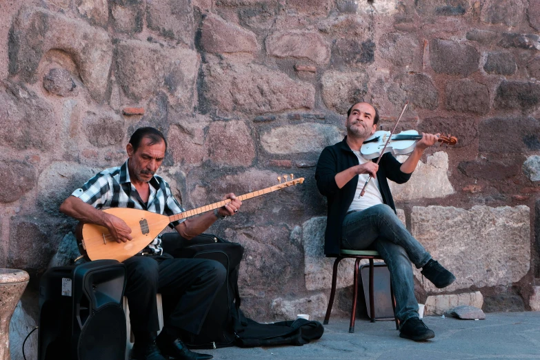 a couple of men sitting next to each other playing instruments, by Luis Molinari, pexels contest winner, les nabis, damascus, tlaquepaque, live performance, flattened