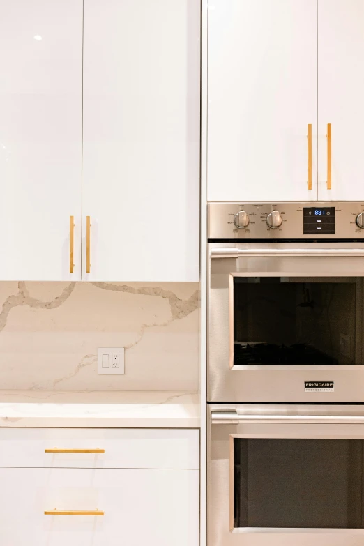 a kitchen with white cabinets and stainless steel appliances, unsplash, modernism, gold detailed line work, closeup photograph, facing front, white background