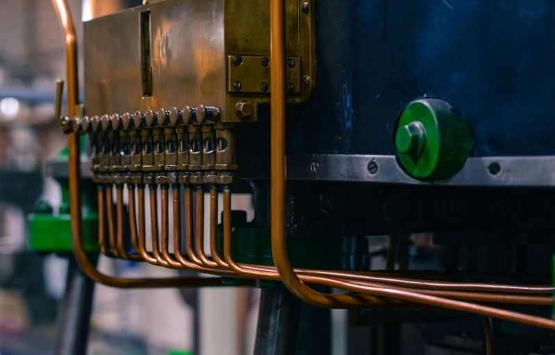 a close up of a machine in a factory, by David Simpson, pexels contest winner, process art, copper pipers, straight smooth vertical, with tubes and wiring, customers