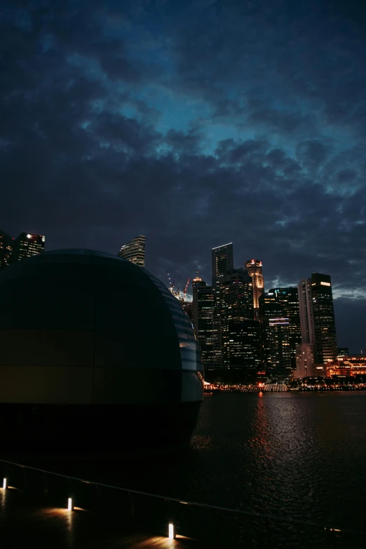 a large boat sitting on top of a body of water, happening, neon city domes, moody evening light, singapore, sleepy