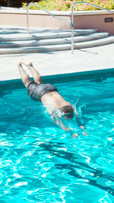 a man swimming in a pool with a frisbee, unsplash, diving suit, low quality photo, face down, ignant