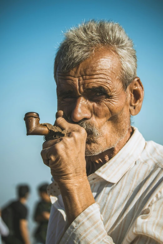 an old man smoking a pipe on the beach, by Ibrahim Kodra, pexels contest winner, renaissance, real life photo of a syrian man, brass horns, 15081959 21121991 01012000 4k, single bangla farmer fighting