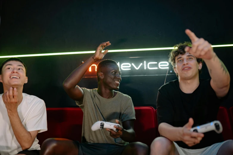 a group of men sitting on top of a red couch, pexels, renaissance, gamer screen on metallic desk, arcade, declan mckenna, nuri iyem