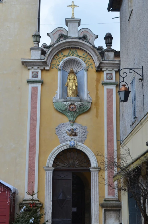 a building with a statue on the front of it, inspired by Bartolomeo Vivarini, yellow aureole, shrines, charlize, nice