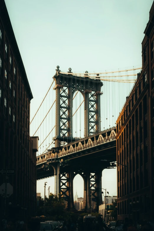 a view of a bridge over a city street, inspired by Elsa Bleda, unsplash contest winner, harlem renaissance, tall structures, frank gehry, 1910s architecture, 2000s photo