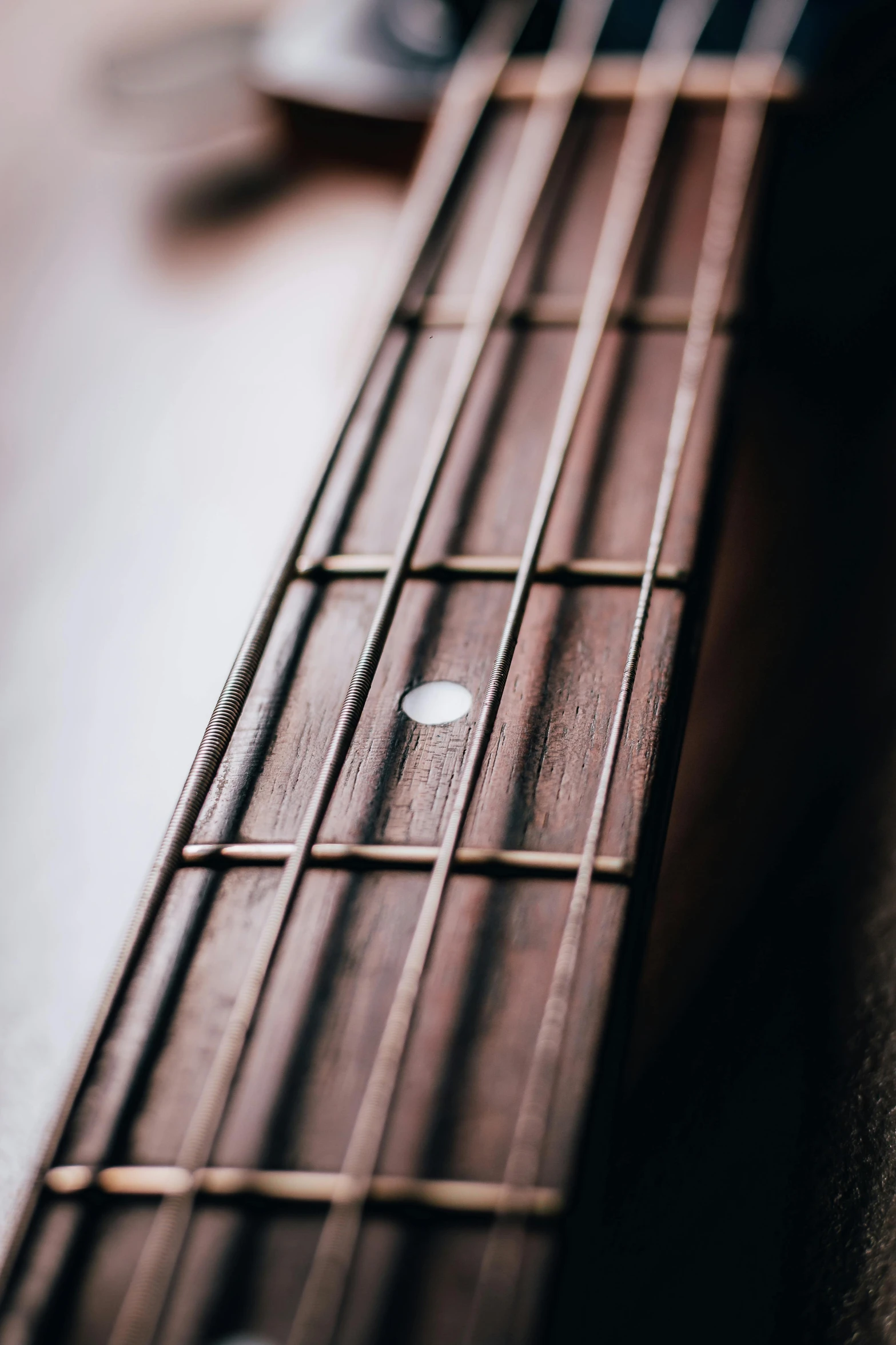 a guitar sitting on top of a wooden table, up-close, metal bars, ilustration, zoomed in shots