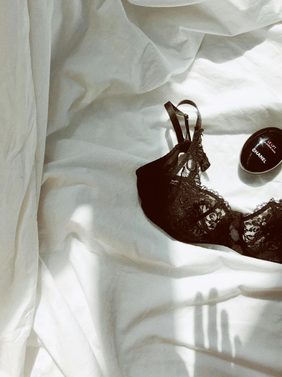 a pair of shoes sitting on top of a bed, a still life, inspired by Elsa Bleda, pexels contest winner, black bra, black eyepatch, instagram story, :: morning