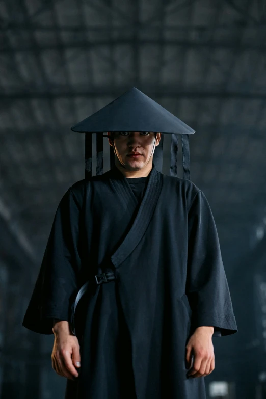 a man in a black robe and a black hat, inspired by Kanō Hōgai, unsplash, sci-fi movie still, with acient chinese clothes, lee madgwick & liam wong, production photo
