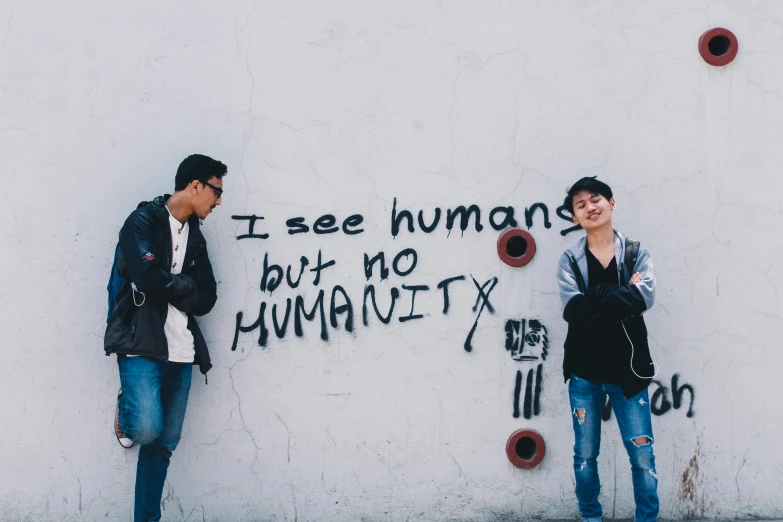 two people standing next to a wall with graffiti on it, an album cover, pexels contest winner, humanity's last sacrifice, hsiao-ron, human : - 2, cute boys