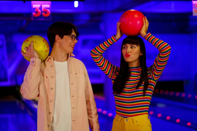 a man and a woman standing next to each other holding bowling balls, an album cover, pexels, belle delphine, 8 0 s asian neon movie still, john egbert, teenager hangout spot