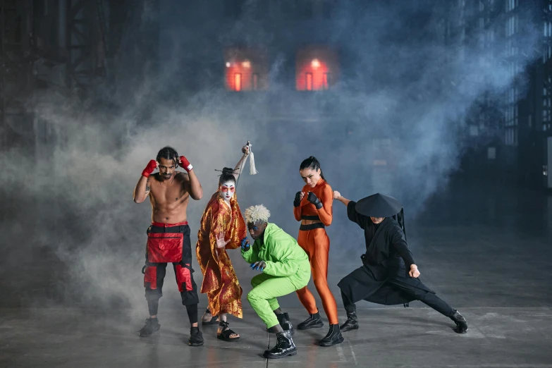 a group of people standing next to each other on a stage, inspired by Ma Quan, trending on pexels, gutai group, ninja outfit, fire fight, glamourous cosplay, posing for a fight