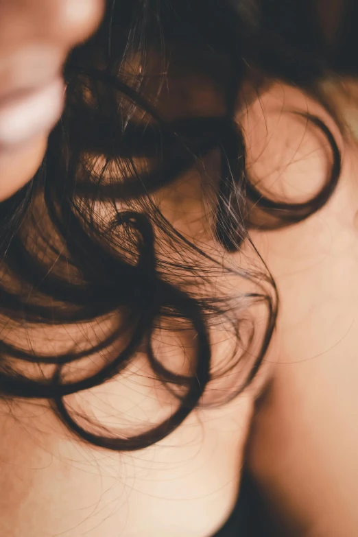 a close up of a person holding a cell phone, long curl hair, bedhead, hair texture, with black hair