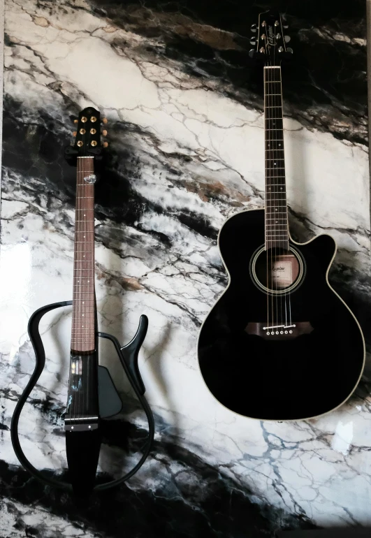 a couple of guitars sitting on top of a marble counter, pexels contest winner, vantablack wall, ivory and ebony, 💣 💥💣 💥, greg rutkowski ”