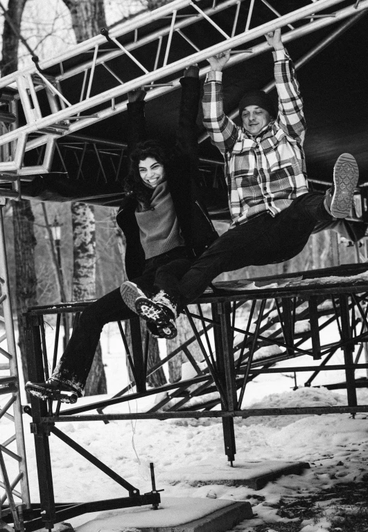 a man flying through the air while riding a skateboard, a black and white photo, graffiti, chairlifts, yoshitaka amano and junji ito, looking at camera!!!, in the winter