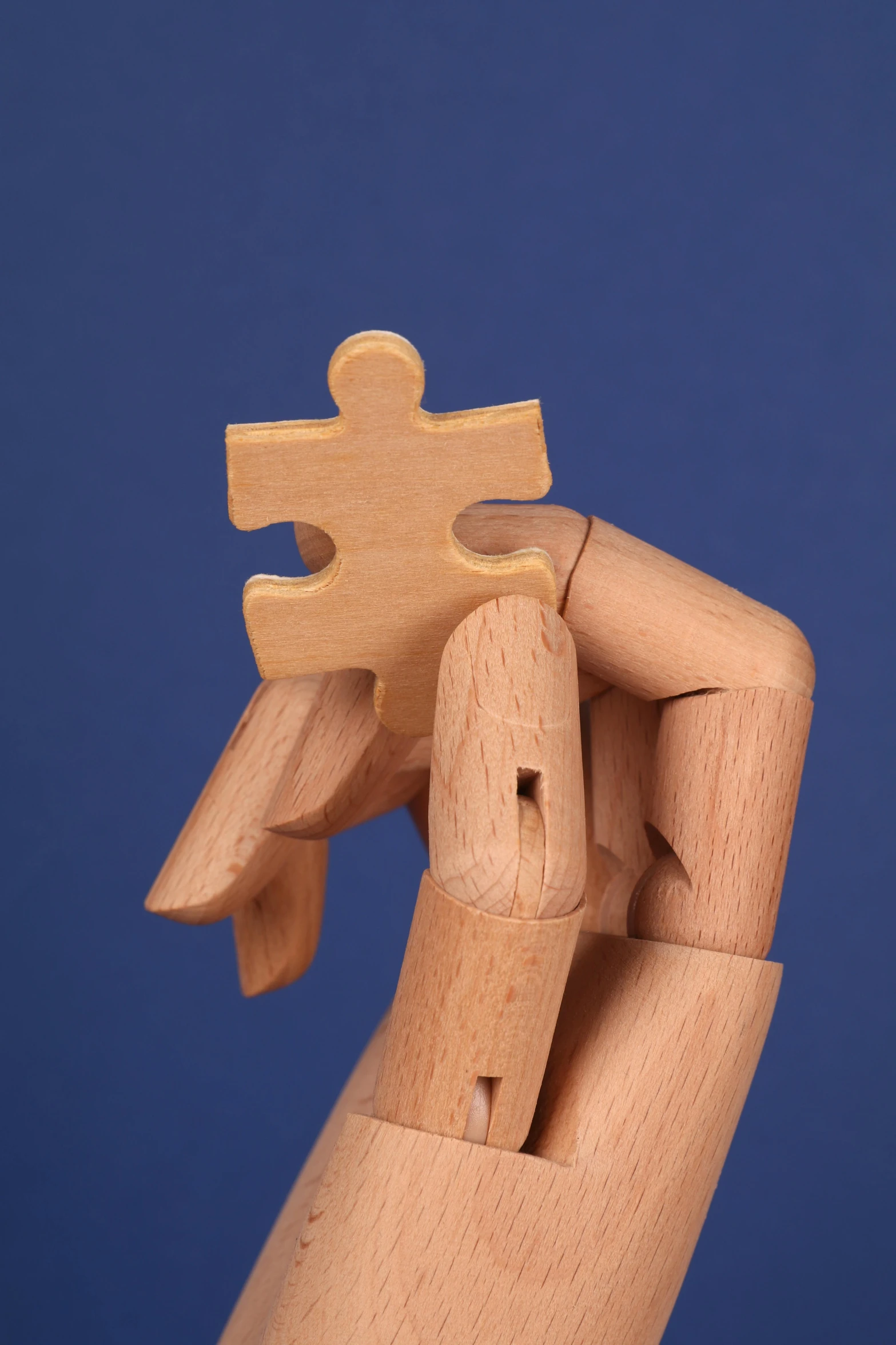 a wooden hand holding a piece of a puzzle, inspired by Ossip Zadkine, unsplash, articulated joints, ilustration, model pose, stacked image