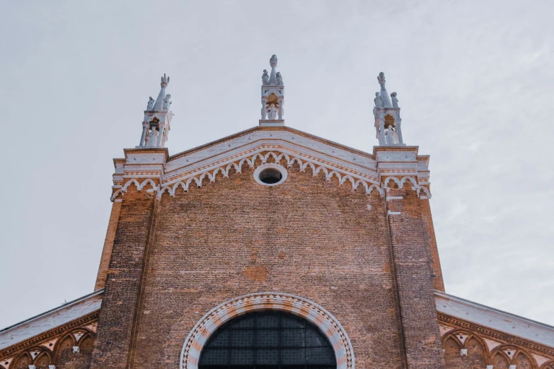 a large brick building with statues on top of it, inspired by Taddeo Gaddi, pexels contest winner, standing inside of a church, venice, profile image, symmetrical front view