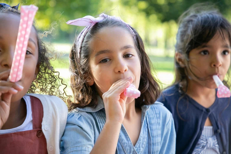a group of young girls standing next to each other, a picture, by Adam Marczyński, shutterstock, blowing bubblegum, picnic, 15081959 21121991 01012000 4k, soft lulling tongue