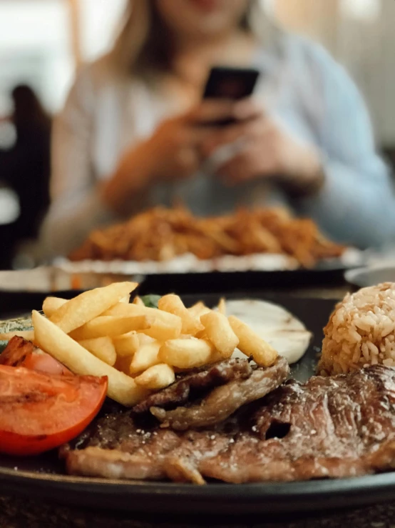 a close up of a plate of food on a table, by Joe Bowler, pexels contest winner, realism, snapchat photo, são paulo, beef, with fries