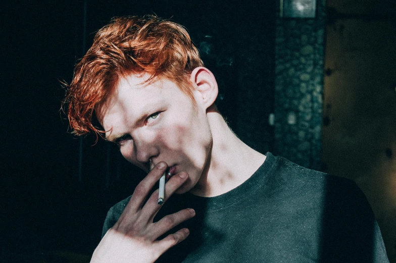 a man with red hair smoking a cigarette, inspired by Nan Goldin, unsplash, pale glowing skin, demon boy, ignant, stock and two smoking barrels