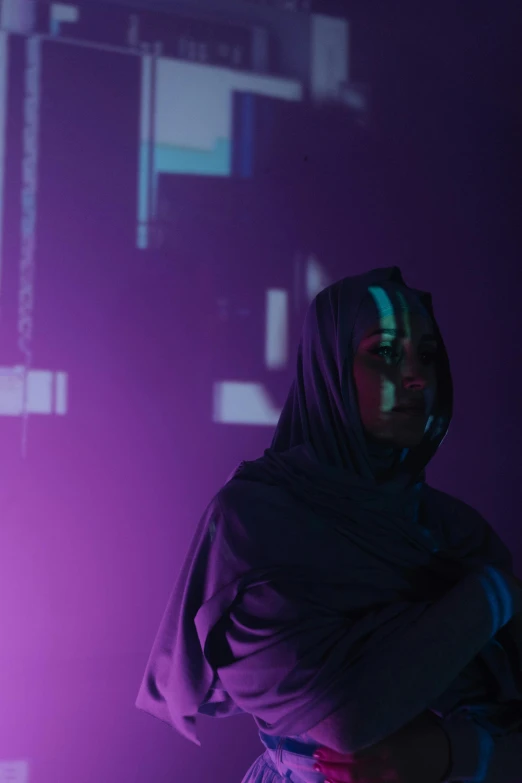 a woman standing in front of a projection screen, pexels contest winner, holography, purple robe and veil, cyberpunk mosque interior, scene from a rave, portrait of an android