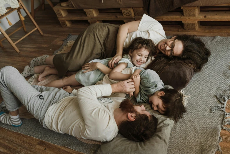 a group of people laying on top of a floor, caring fatherly wide forehead, cottagecore, profile image, thumbnail