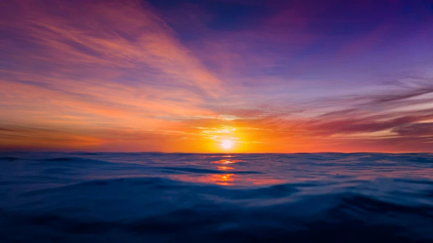 a large body of water with a sunset in the background, a picture, deep in the ocean, deep purple and orange, orange and blue sky, kimberly asstyn