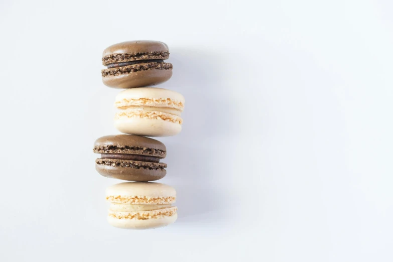 a stack of macarons sitting on top of each other, unsplash, gradient brown to white, a high angle shot, three fourths view, thumbnail