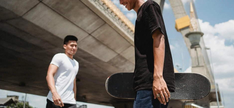 a man holding a skateboard next to another man, pexels contest winner, wearing a black tshirt, thawan duchanee, thumbnail, rounded corners