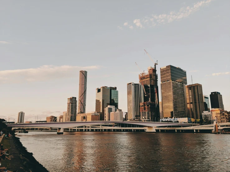 a large body of water with a city in the background, by Lee Loughridge, pexels contest winner, lachlan bailey, building along a river, instagram story, skyline showing