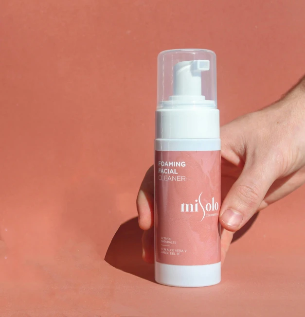 a person holding a bottle of hand sanitizer, by Micha Klein, happening, blush, whipped cream, ryden, product picture