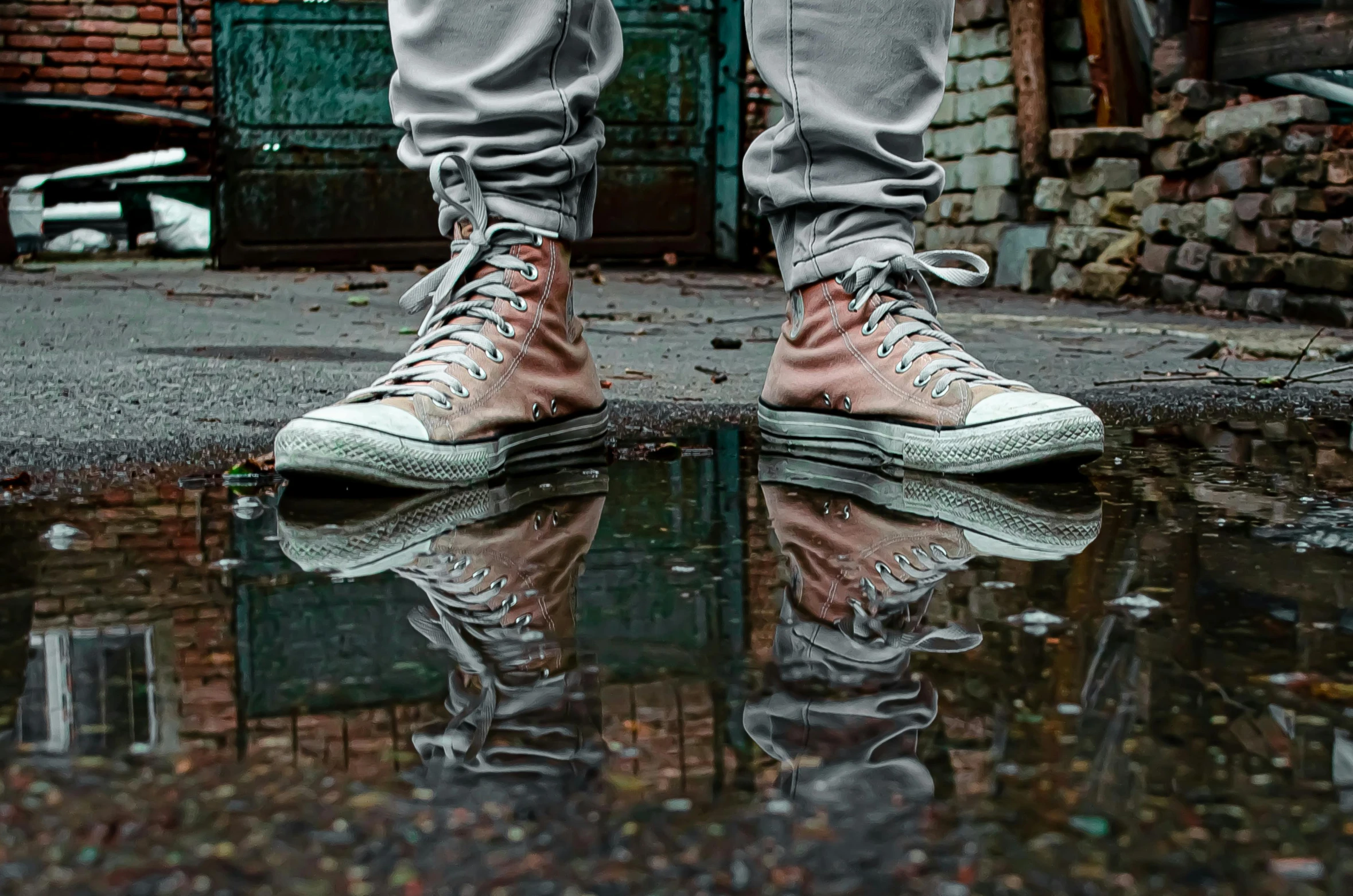 a person standing on top of a puddle of water, pexels contest winner, hyperrealism, sneaker shoes, sitting in a reflective pool, muted colors. ue 5, aggressive stance