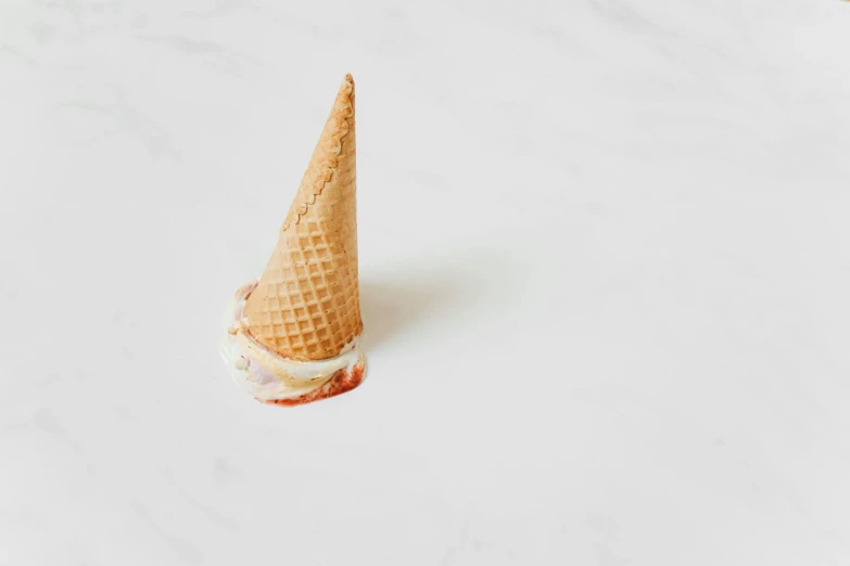 an ice cream cone sitting on top of a table, trending on pexels, white concrete, background image, high - angle view, burned