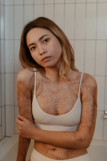 a woman standing in a bathroom next to a bath tub, an album cover, inspired by Elsa Bleda, trending on pexels, hairy body, young asian woman, covered with tar, flawless epidermis