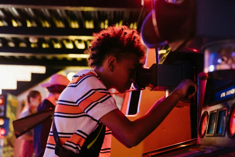 a group of people playing a game of pinball, a portrait, pexels, interactive art, portrait of willow smith, little kid, piloting a small space shuttle, summer festival night