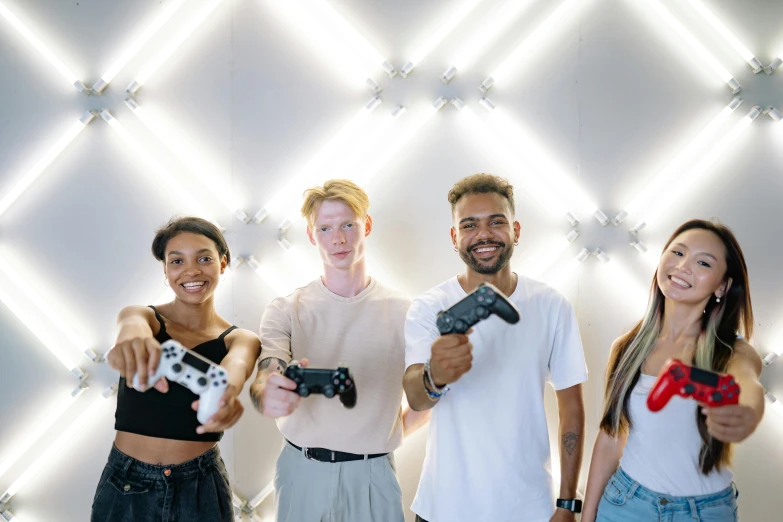 a group of people standing next to each other holding video game controllers, pexels contest winner, interactive art, light skin, bounce lighting, posing for a picture, customers