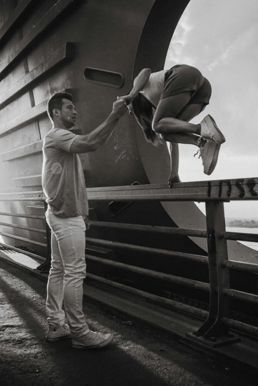 a couple of men standing next to each other on a bench, a black and white photo, pexels contest winner, happening, balance beams, couple dancing, on ship, worksafe. instagram photo