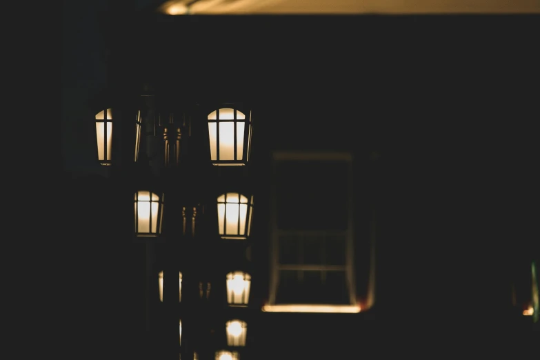 a street light that is lit up in the dark, an album cover, unsplash, light and space, lanterns on the porch, gas lamps, rows of windows lit internally, atmospheric lighting - n 9